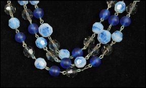 A signed West German three strand glass bead necklace strung with opaline, blue and blue grey
