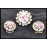 A vintage guilloche enamel brooch pin and clip on earring set having hand painted enamel roses on