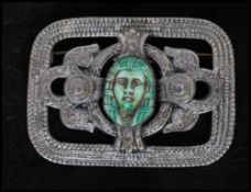 A 1950's silver tone Egyptian revival brooch set with a central Pharaoh. Measures 2 inches.