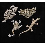 A collection of marcasite brooches to include frog and lizard, a spray brooch. Together with a