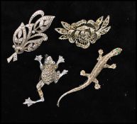 A collection of marcasite brooches to include frog and lizard, a spray brooch. Together with a