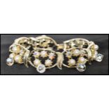 A 1950s vintage signed gold-tone Coro bracelet set with AB rhinestones faux pearls with AB drops.