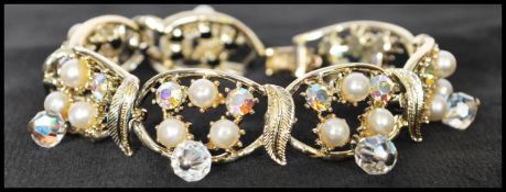 A 1950s vintage signed gold-tone Coro bracelet set with AB rhinestones faux pearls with AB drops.
