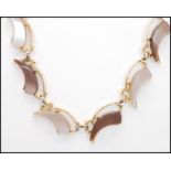 A 1950's silver-tone black and pearl grey lucite necklace together with a similar brown and beige