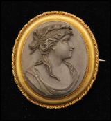 A Victorian gold lava cameo brooch having a lava cameo in a gold mount. Unmarked. Measures 2