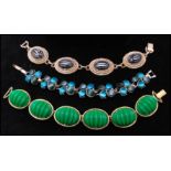 A gold-tone signed Monet thermoset bracelet having vibrant green stylised cabochons together with