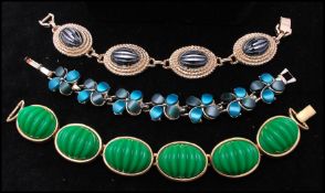 A gold-tone signed Monet thermoset bracelet having vibrant green stylised cabochons together with