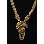 A 1950s signed Miriam Haskell gold-tone parure decorated with faceted gold beads, filigree work and