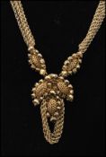 A 1950s signed Miriam Haskell gold-tone parure decorated with faceted gold beads, filigree work and