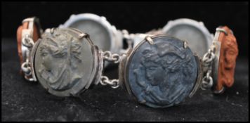 A Victorian silver lava cameo 6 panel bracelet having grey and terracotta lava cameos in a partial