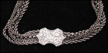 A Victorian silver multi strand chain bracelet having etched fittings with later hoop clasp,