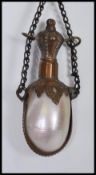 A Victorian French Mother of Pearl chatelaine stoppered perfume bottle with etched metal mounts