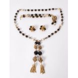 A signed vintage Hobé demi parure consisting of necklace bracelet and earrings strung with pearls