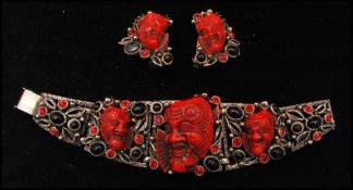 A 1950s signed Selro Selini silver tone red devil Noh mask Asian face bracelet and earrings set