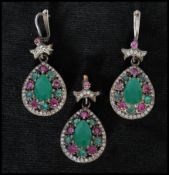 A 925 silver ruby and synthetic emerald earring and pendant set. Marked 925. Pendant approx 4cm.