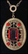 A 1920's Czech pendant necklace the pendant being set with a large faceted red glass gem, with