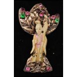 A 1940s Hobé Asian Lady brooch pin featuring a carved faux ivory Asian lady, wearing a tinted robe