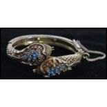 A vintage signed Art, Arthur Pepper gold-tone snake bangle with turquoise bead decoration having red