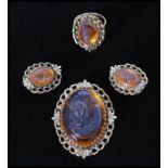 A vintage signed Whiting and Davis amber glass cameo parure set consisting of a gold-tone necklace