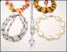 A collection of vintage plastic lucite and carved celluloid necklaces, earrings and bracelet to
