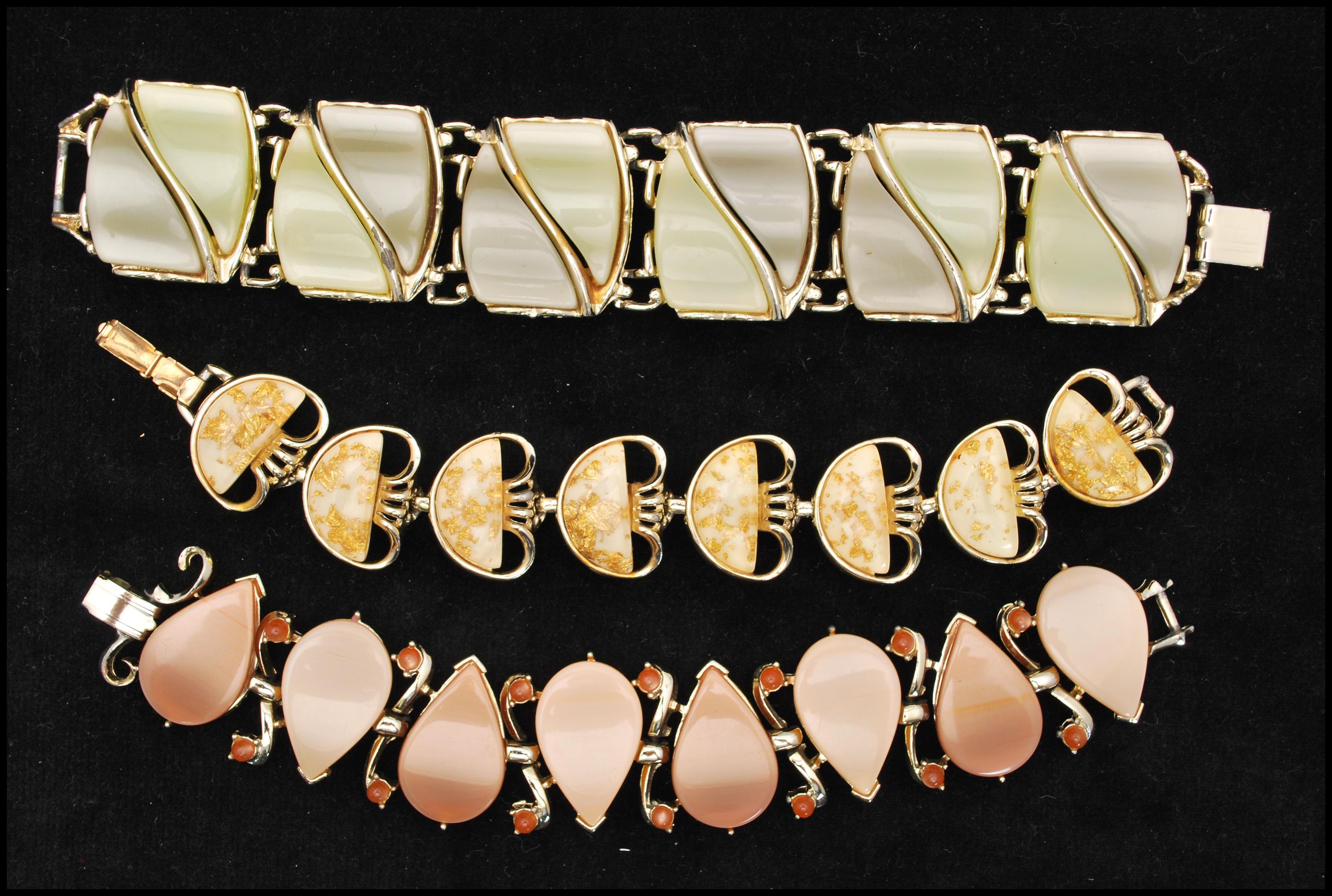 Three 1950s thermoset and lucite bracelets to include a signed Coro confetti lucite bracelet, a tear
