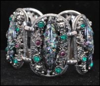 A 1950s silver-tone Selro Selini 5 link confetti lucite and rhinestone bracelet set with green and