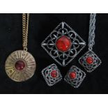 A 1970's signed Sarah Coventry 1976 Inca Fire silver-tone pendant brooch necklace and earring set