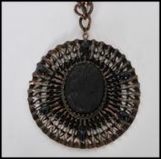 A vintage Victorian revival  oversized pendant necklace having a central jet black glass cameo