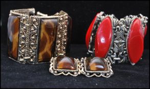 A 1950s gold-tone four panel bracelet and earring set being set with animal print style lucite