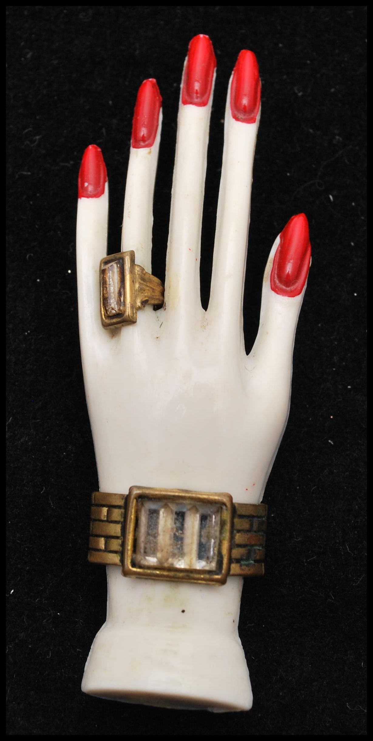 A 1930s Art Deco French celluloid brooch in the form of a graceful hand set with jewellery, paste