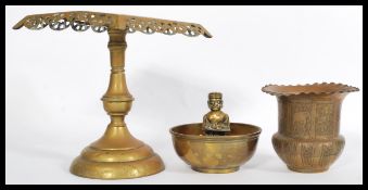 A selection of brass items to include a prayer bow