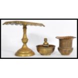 A selection of brass items to include a prayer bow