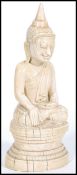 An 18th century Burmese carved ivory buddha sat in the lotus position with beatific expression,