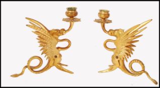 A PAIR OF 19TH CENTURY GILT BRASS SINGLE SCONCE GRIFFIN CANDLESTICKS