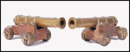 EARLY 20TH CENTURY GOOD DESK TOP OAK AND BRASS PAIR OF CANNONS