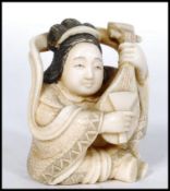 JAPANESE MEIJI PERIOD CARVED OKIMONO IN THE FORM OF A GEISHA WITH MANDOLIN