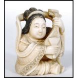 JAPANESE MEIJI PERIOD CARVED OKIMONO IN THE FORM OF A GEISHA WITH MANDOLIN