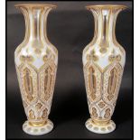 A 19TH CENTURY BOHEMIAN OVERLAY FACED CUT GLASS PAIR OF VASES