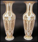 A 19TH CENTURY BOHEMIAN OVERLAY FACED CUT GLASS PAIR OF VASES