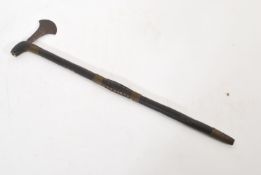 An African tribal art war club with small worked axe head, the shaft with wire binding and