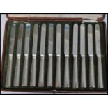 Am early 20th century cased set of twelve silver hallmarked knives by Elkington being hallmarked for