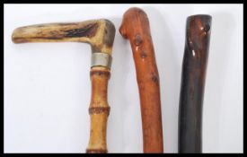 A collection of three 20th Century walking sticks / canes to include a bamboo stick having a