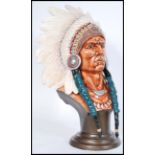 A vintage porcelain head bust of a Native American Red Indian Chief with detailed features raised on