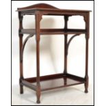 A Victorian mahogany twin tier side table in the manner of EW Godwin. The squared legs with canted