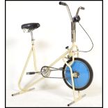 A vintage mid 20th Century  tubular frame exercise bike, low millage speedometer, tension adjustable