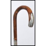 A silver hallmarked collared and mounted walking cane, London assay marks, curved crook handle