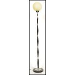 A retro mid century, circa 1960's standard lamp - floor lamp of ebonised finished being raised on