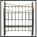 A 19th Century Victorian cast iron three quarter sized double bed frame with brass finials and
