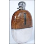 A vintage 20th century silver plated and crocodile skin hop flask of larger form. The oval glass
