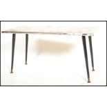 A mid century retro coffee - occasional table being raised on black dansette tapering legs with a